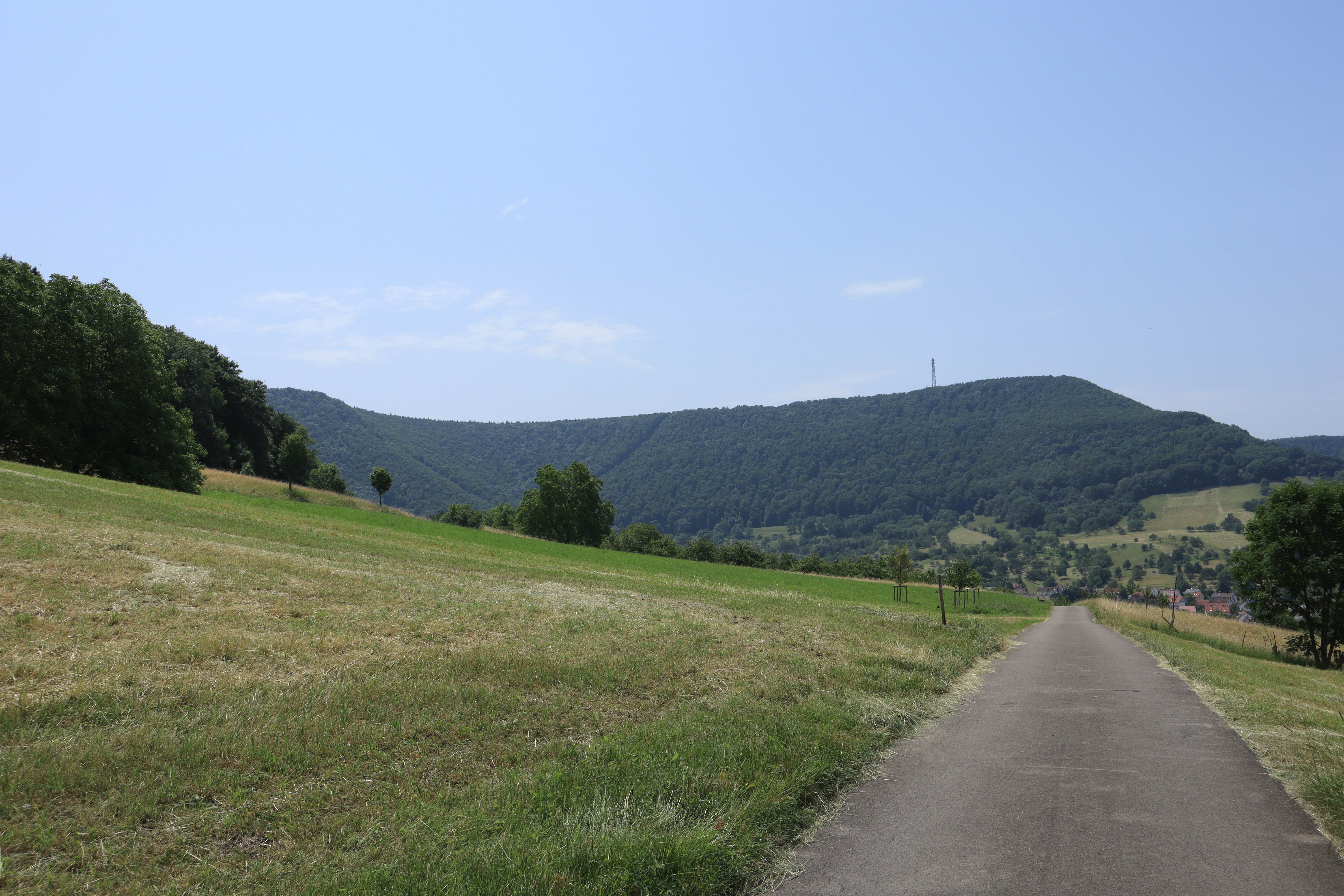 Looking down on a cycling trail while hills are visible in the background.