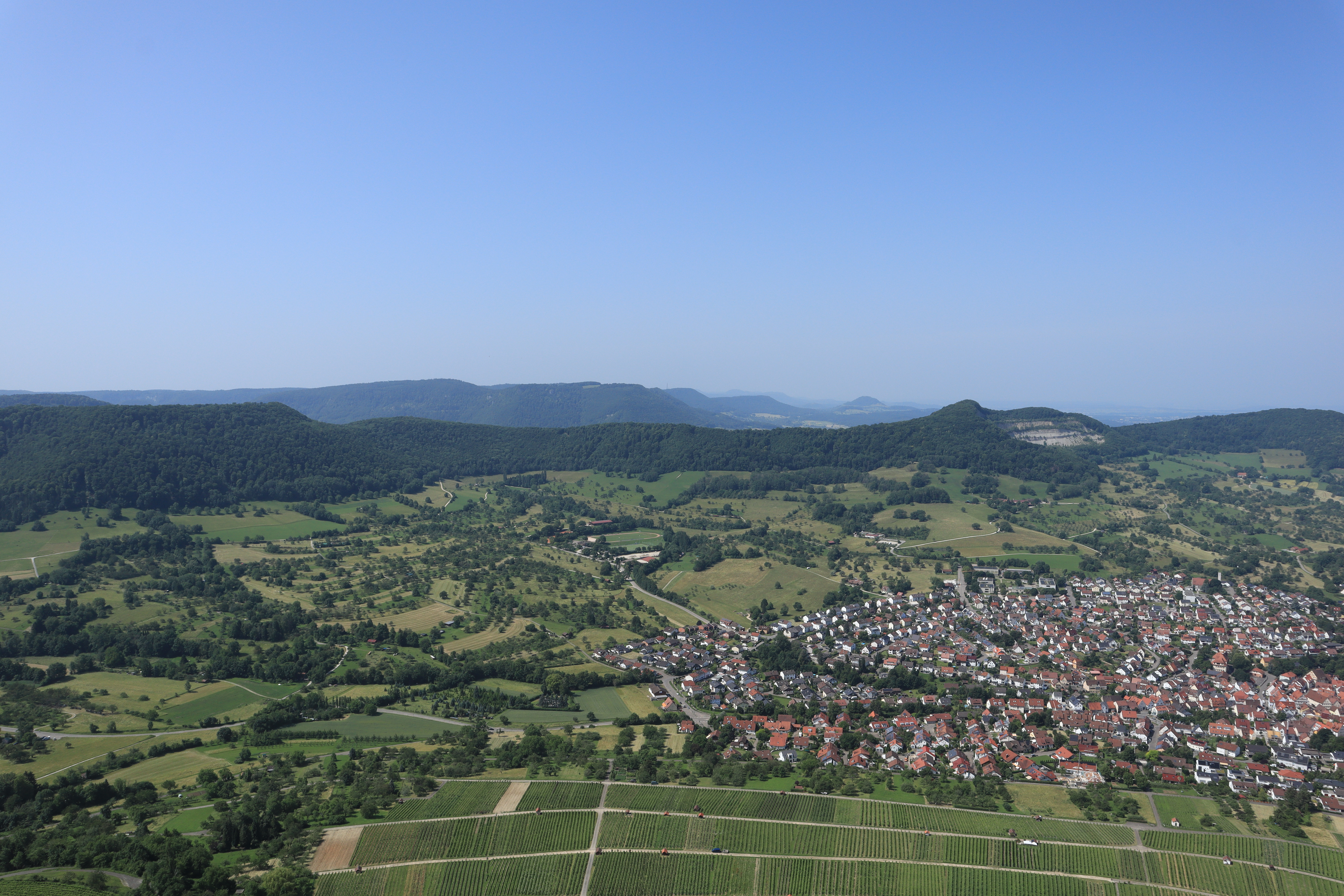 Hills, villages and curving roads seen from the top of the tallest hill.