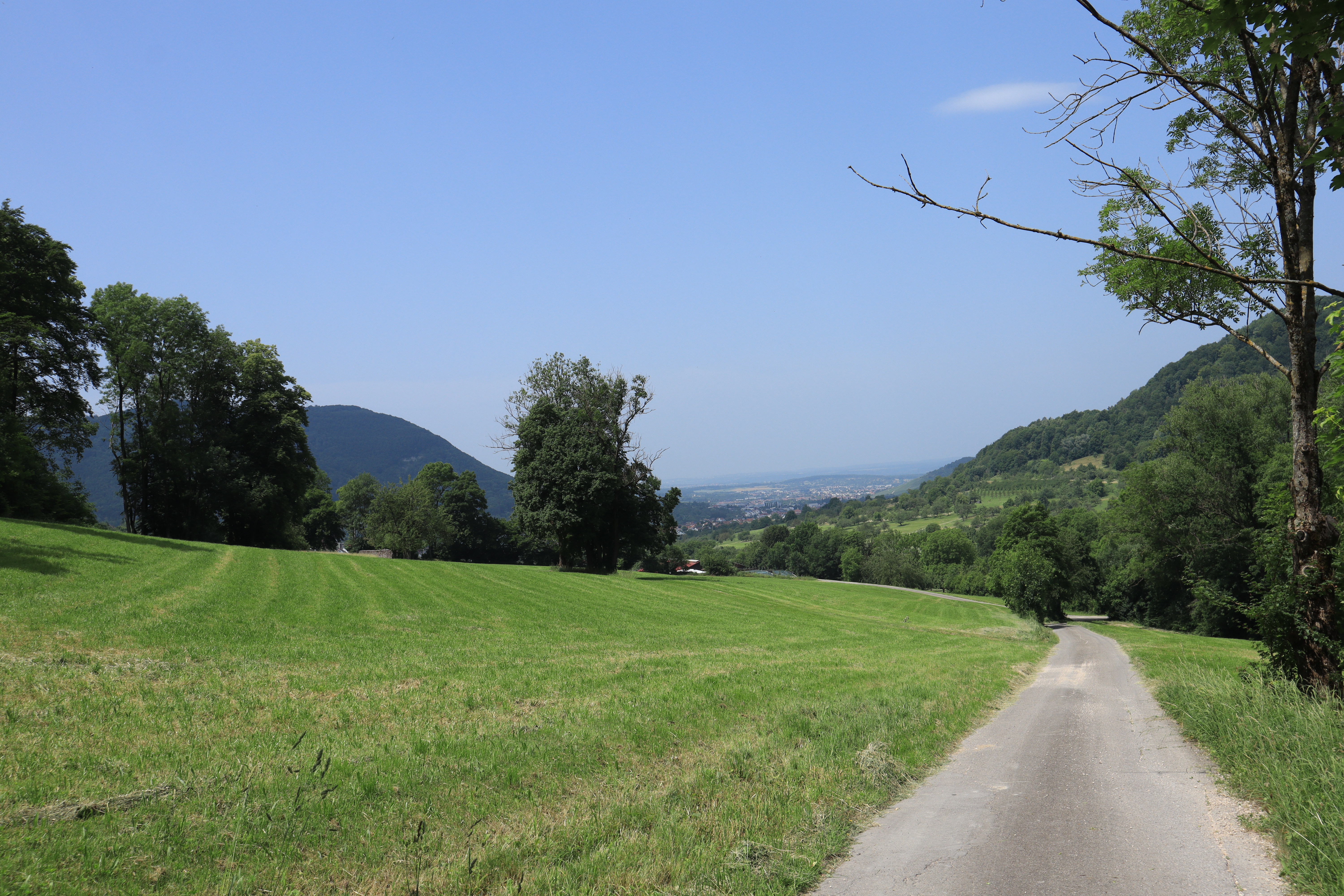 Looking down on a cycling trail while hills are visible in the background.