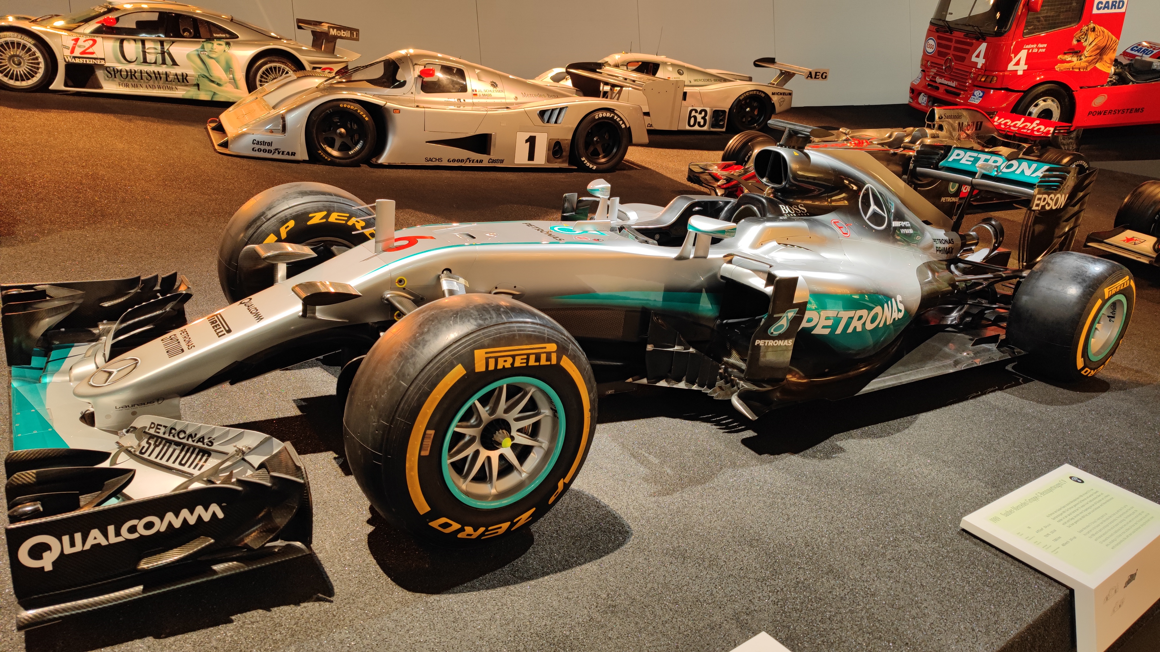 Exhibition of Formula-1 and other race cars in a museum.