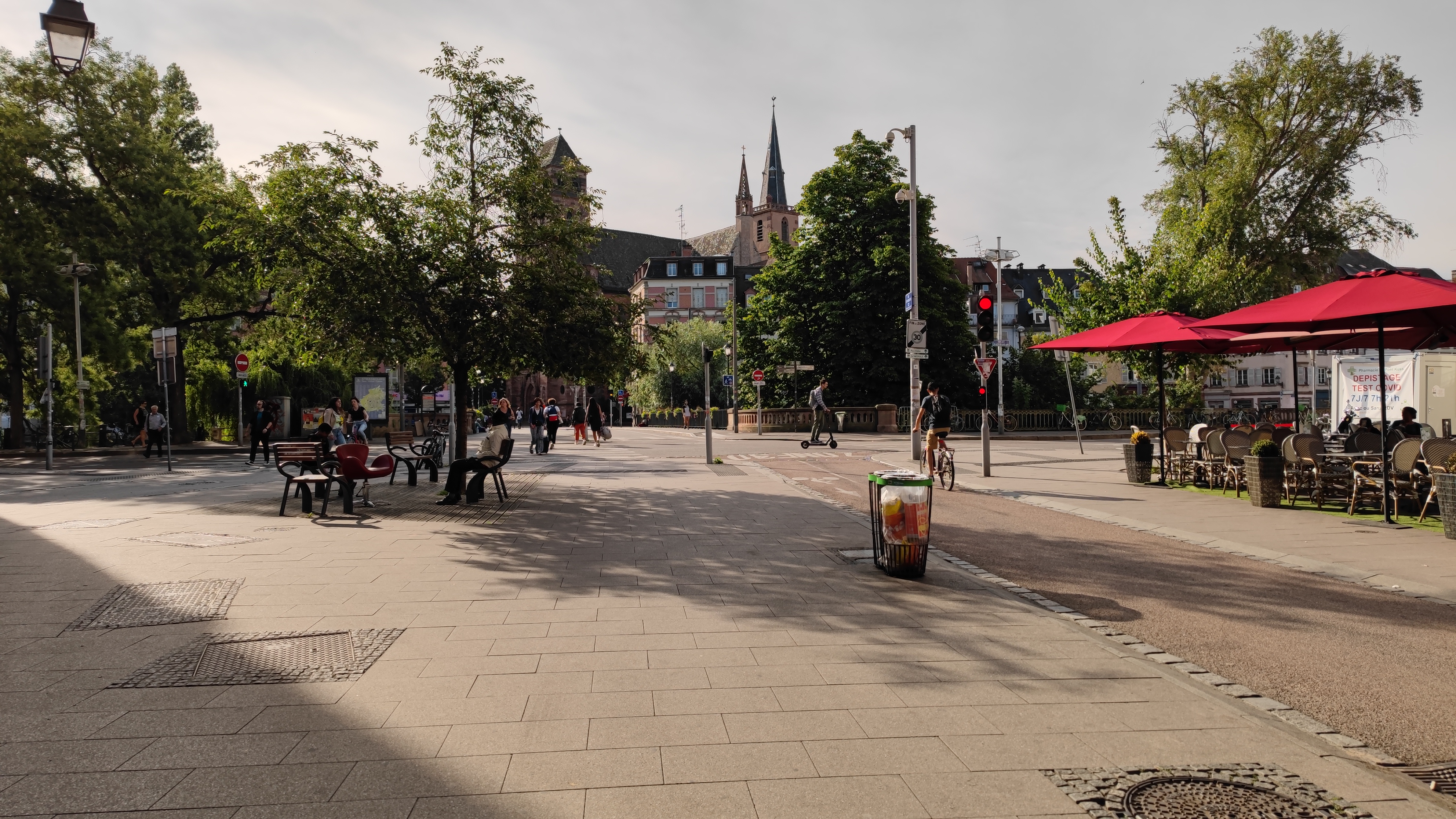 A small but nice square in a town. There are small streets for cars and large walking areas.