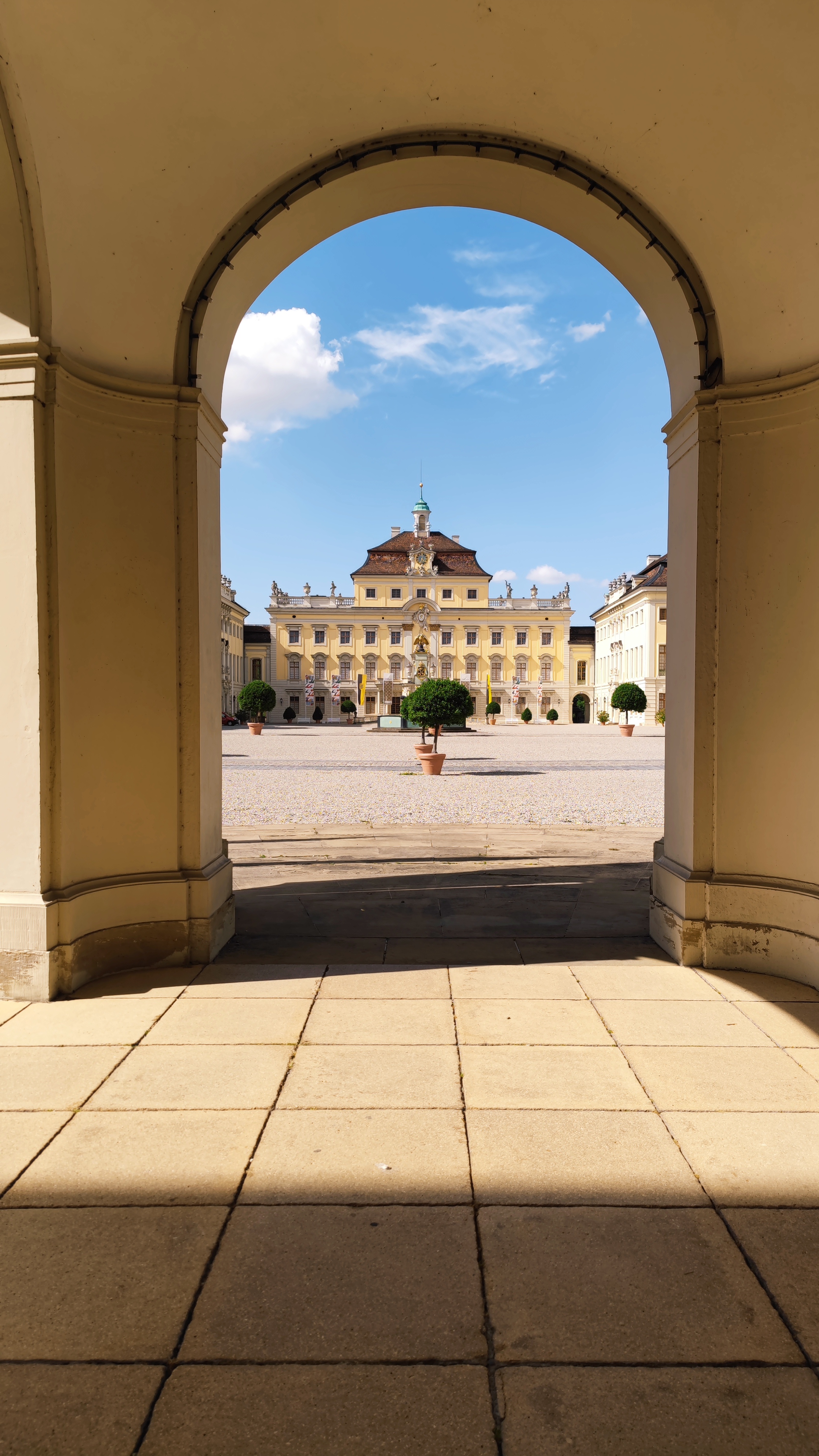 Looking at the old building of the palace of Ludwigsburg through an arch.