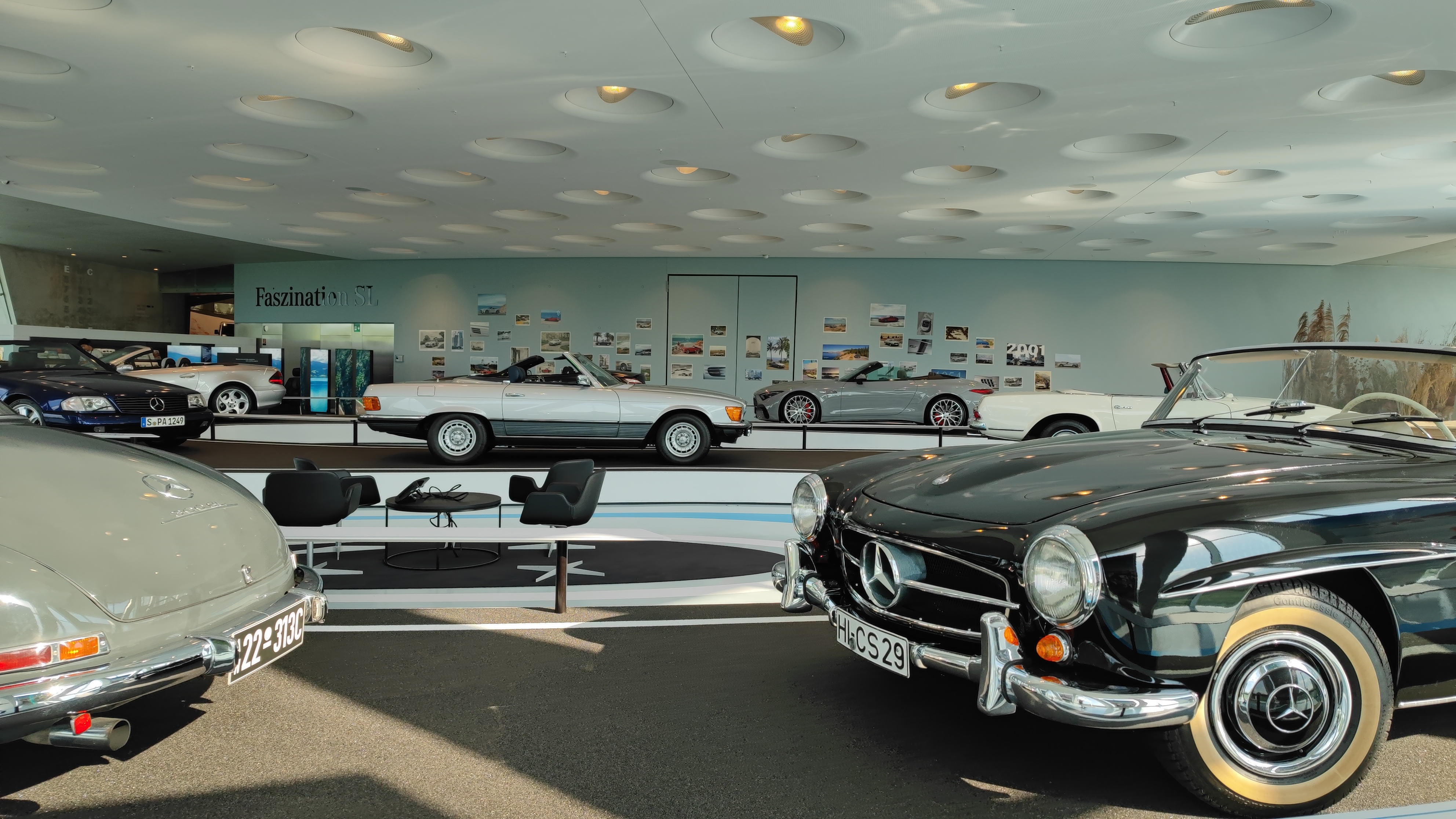 Exhibition of older Mercedes models in a museum.